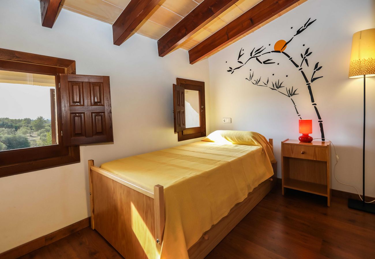 Schlafzimmer mit einem Einzelbett der Finca Bonany bei Petra