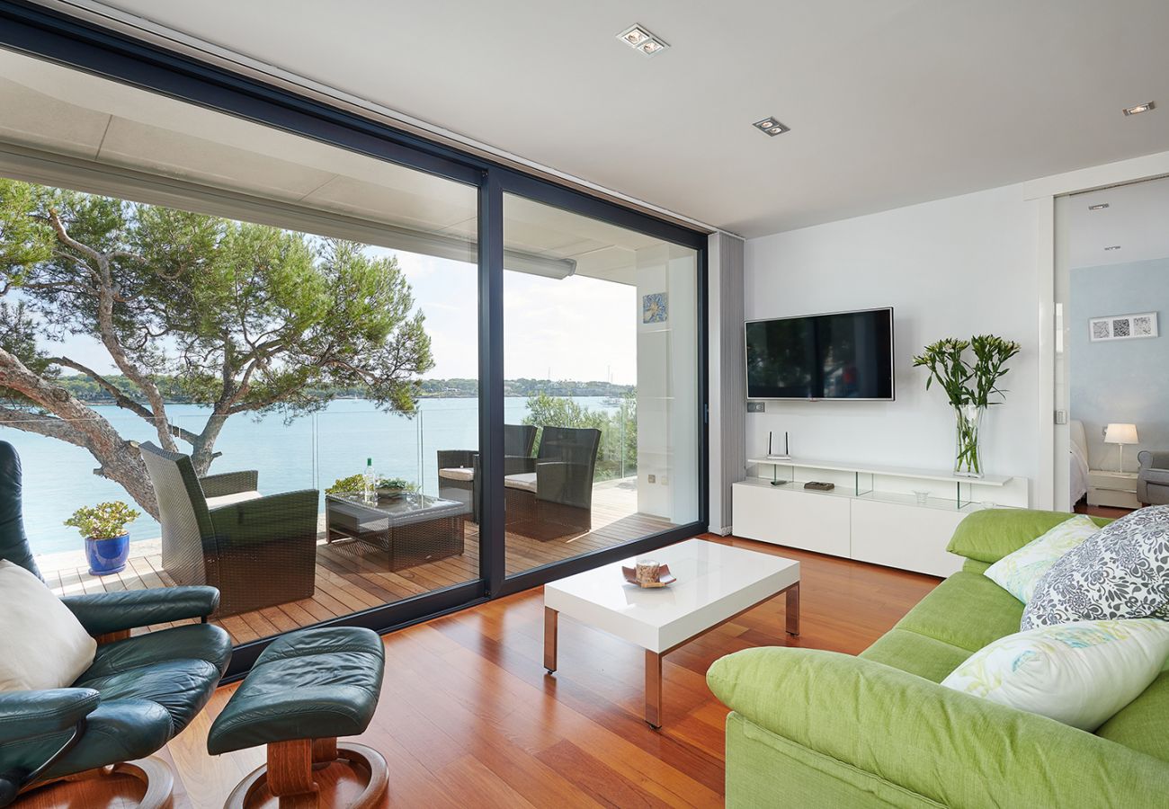 helles Wohnzimmer mit Meerblick und gemütlicher Sitzecke der Ferienwohnung Faro I in Portocolom
